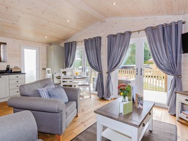 A living room with a sofa and table at Typhoon Lodge in Winchester