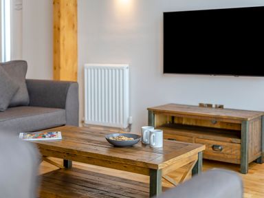 A living room with a coffee table and television at Tranquillity 3 in Warton near Carnforth