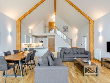 A living room with a sofa and dining table at Tranquillity 3 Warton near Carnforth