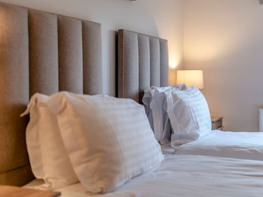A bedroom with two beds and a lamp at Tranquillity 3 Warton near Carnforth