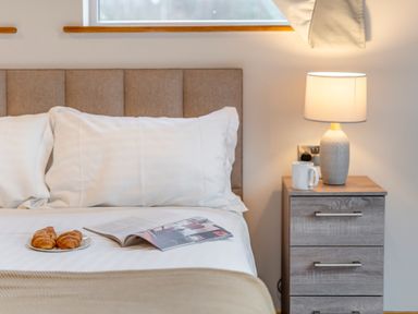 A bedroom with a bed and nightstand at Tranquillity 3 in Warton near Carnforth
