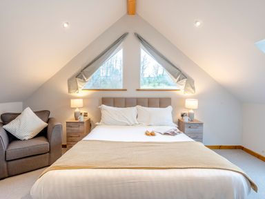 A bedroom with a bed and armchair at Tranquillity 3 Warton near Carnforth