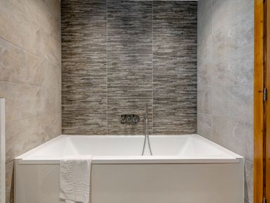 A bathroom with a bathtub and faucets at Tranquillity 3 in Warton near Carnforth