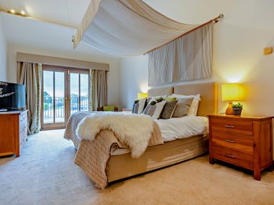 A bedroom with a bed and bedside table at Barley Park in Marhamchurch