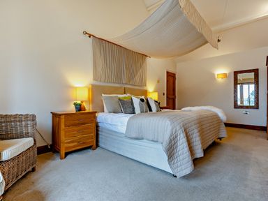 A bedroom with a bed and nightstand at Barley Park in Marhamchurch