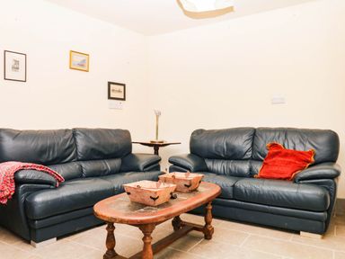 A living room with sofas and a coffee table at The Gables in Teignmouth