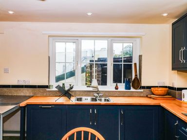 A kitchen with a sink and window at The Gables in Teignmouth
