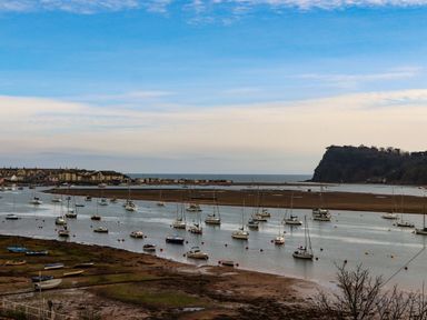 A view of boats in a harbor with a shore at The Gables in Teignmouth