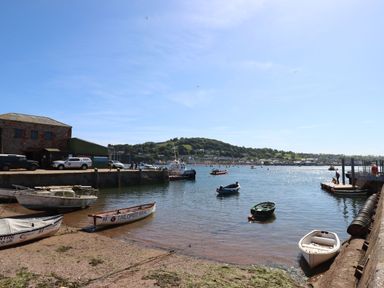 A view of a harbor with boats and buildings at The Gables in Teignmouth