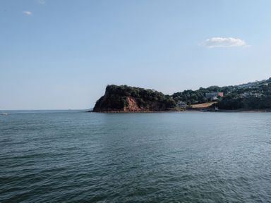 A view of an island and surrounding hills over water at 4 The Gables Teignmouth