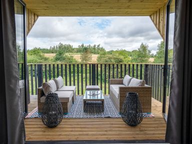 An outdoor living area with sofa and table at Orka 1.0 Spa (Pet) Dumfries