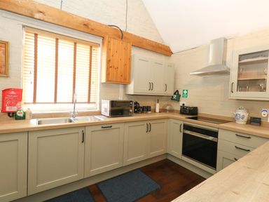 A kitchen with a sink and appliances at The Old Barn in Stourton Caundle near Stalbridge