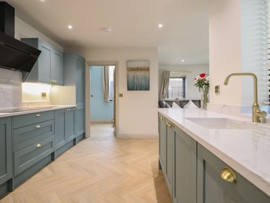 A kitchen with cabinets and a sink at Pistyll Ddu in Brynsiencyn near Llanfairpwllgwyngyll