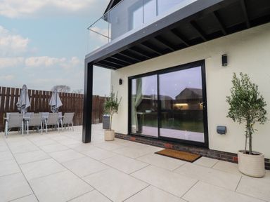 An outdoor patio with table and chairs at Pistyll Ddu in Brynsiencyn near Llanfairpwllgwyngyll
