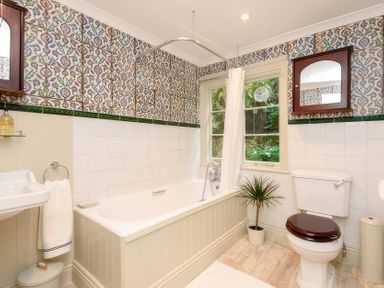 A bathroom with a bathtub and sink at Ladye Park in Liskeard