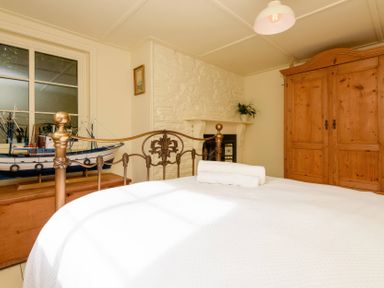 A bedroom with a bed and a wardrobe at Ladye Park in Liskeard
