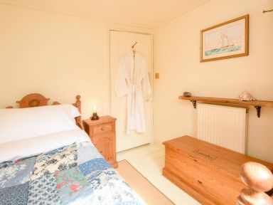 A bedroom with a bed and a chest at Ladye Park in Liskeard