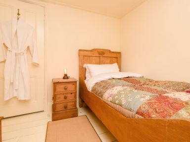 A bedroom with a bed and bedside table at Ladye Park in Liskeard