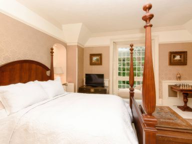 A bedroom with a bed and television at Ladye Park in Liskeard