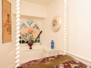 A bedroom with a decorative fan and wall art at Ladye Park in Liskeard