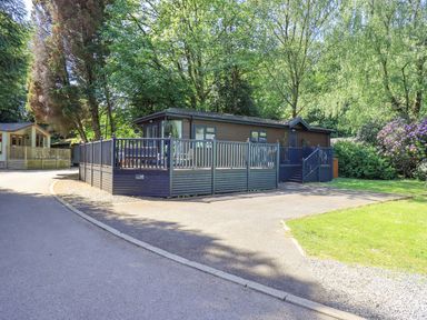 A lodge with decking and fence at Evermore Lodge 48 Calgarth Park, White Cross Bay, Windermere