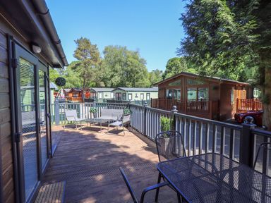 An outdoor area with a deck and seating at Evermore Lodge, 48 Calgarth Park, White Cross Bay, Windermere