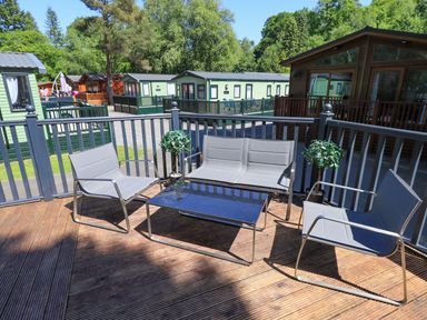 An outdoor seating area with chairs and a table at Evermore Lodge, 48 Calgarth Park, White Cross Bay, Windermere