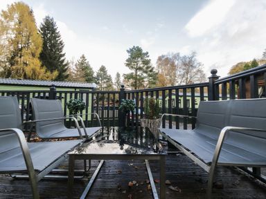 A seating area with chairs and a table at Evermore Lodge, 48 Calgarth Park, White Cross Bay, Windermere