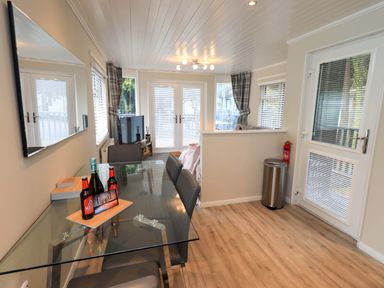 A dining room with a table and chairs at Evermore Lodge, 48 Calgarth Park, White Cross Bay, Windermere