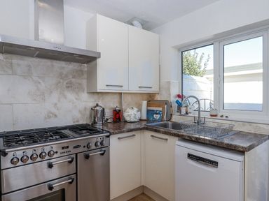 A kitchen with a stove and sink at Woodbury in Teignmouth
