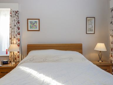 A bedroom with a bed and bedside tables at Woodbury in Teignmouth