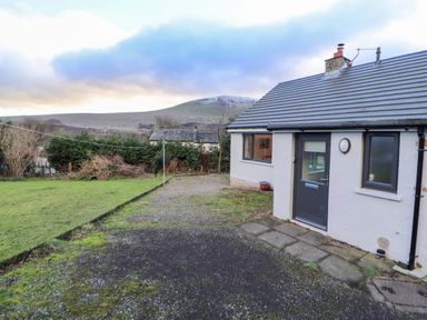 A garden with a house and mountain view at Westerlodge Threlkeld near Keswick