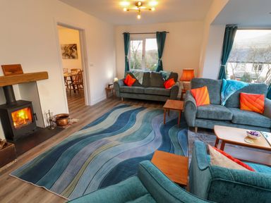 A living room with a fireplace and sofas at Westerlodge in Threlkeld near Keswick