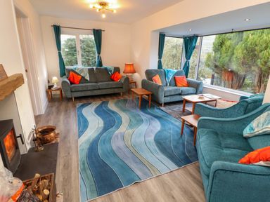 A living room with sofas and a coffee table at Westerlodge Threlkeld near Keswick