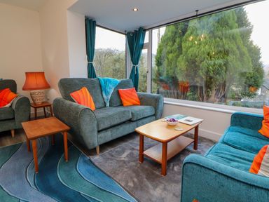 A living room with sofas and a coffee table at Westerlodge Threlkeld near Keswick
