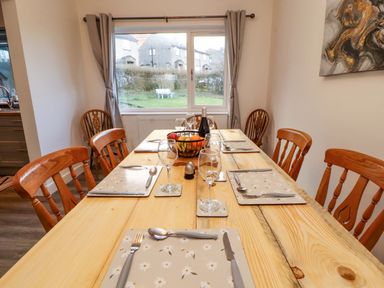 A dining room with a table set for meals at Westerlodge in Threlkeld near Keswick