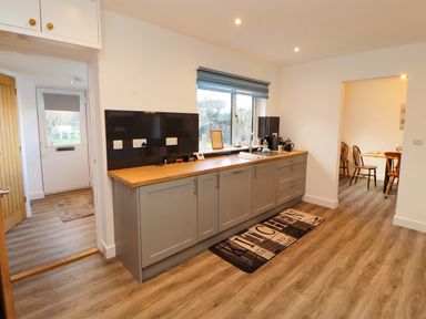 A kitchen with cabinets and a sink at Westerlodge in Threlkeld near Keswick