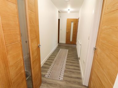 A hallway with doors and a rug at Westerlodge Threlkeld near Keswick