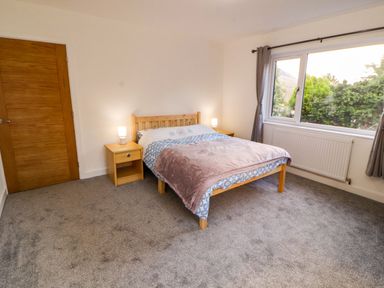 A bedroom with a bed and bedside table at Westerlodge in Threlkeld near Keswick