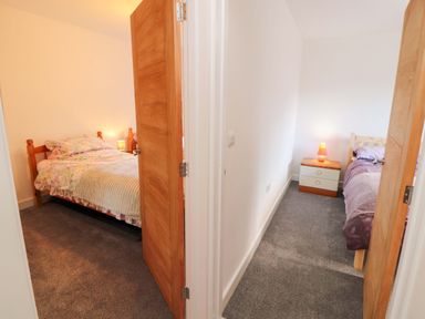 Two bedrooms with beds and nightstands at Westerlodge Threlkeld near Keswick