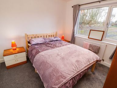 A bedroom with a bed and nightstands at Westerlodge in Threlkeld near Keswick