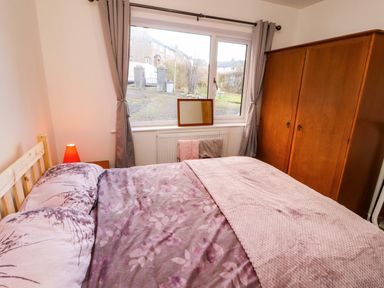 A bedroom with a bed and wardrobe at Westerlodge Threlkeld near Keswick