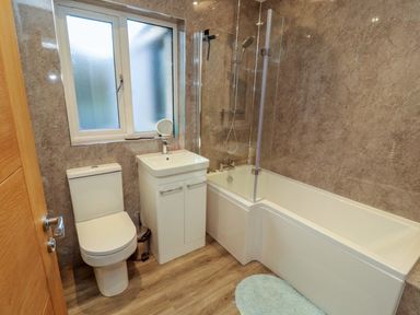 A bathroom with a toilet, sink, and bathtub at Westerlodge Threlkeld near Keswick