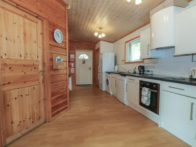 A kitchen with appliances and wooden features at Woodlands View in Leek