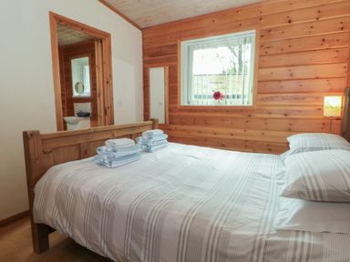 A bedroom with a bed and towels at Woodlands View in Leek