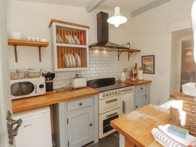 A kitchen with a refrigerator and oven at Rock Cottage in Milnthorpe