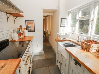 A kitchen with an oven, sink, and countertop at Rock Cottage in Milnthorpe