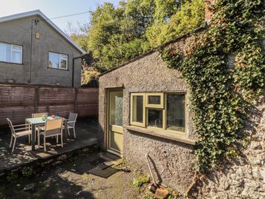 An outdoor area with a table and chairs at Rock Cottage in Milnthorpe