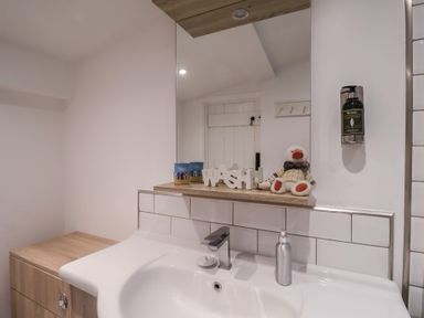 A bathroom with a sink and mirror at Nutshell in Aldeburgh