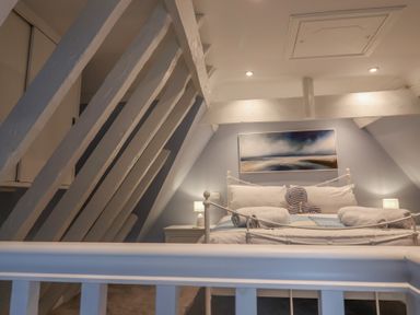 A bedroom with a bed and lamps at The Nutshell in Aldeburgh